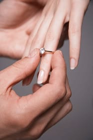 Putting a ring on the finger as they get engaged
