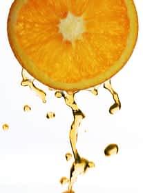 Orange juice droping from orange slice