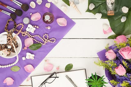 How To Make Buying Jewellery More Personal flat lay with purple, flowers, jewellery, glasses and a book